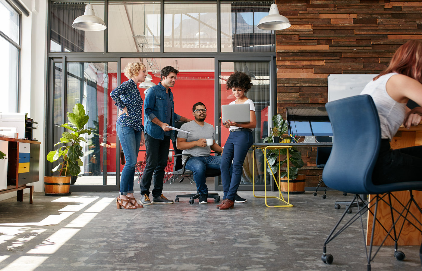 People collaborating at a table with a laptop